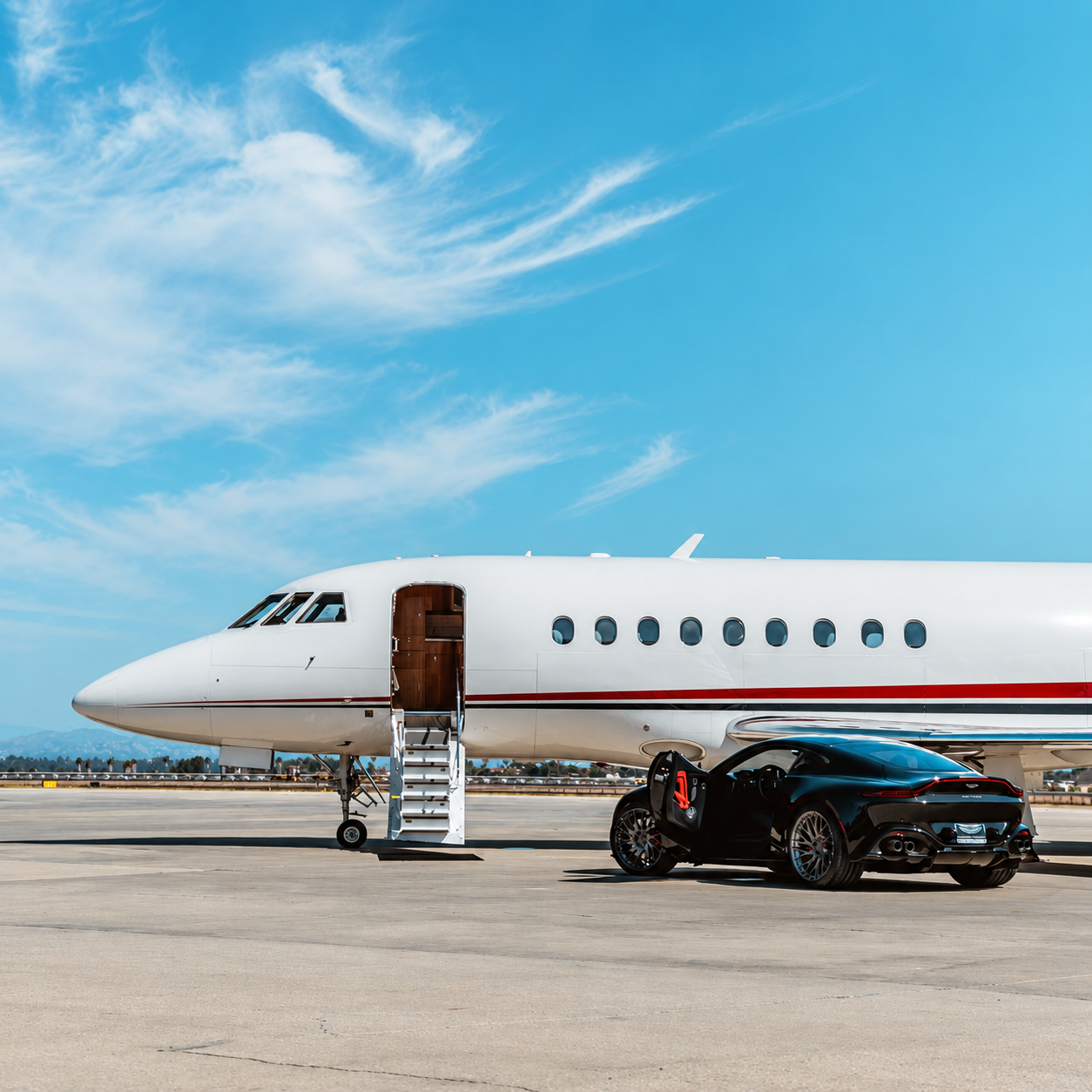 Private jet and luxury car on the runway
